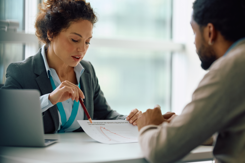 A woman and man discussing a document together.