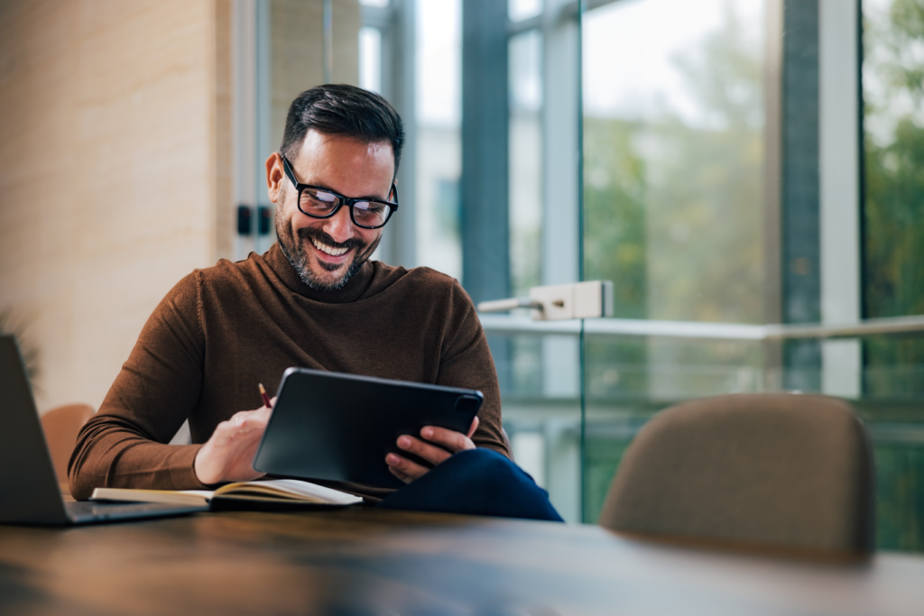 Man using tablet at modern boardroom table