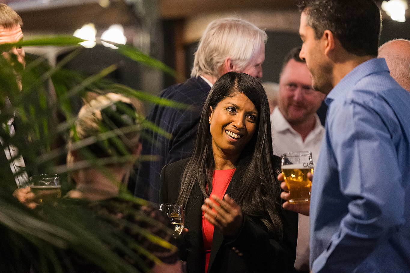 A male and female networking at an alumni event